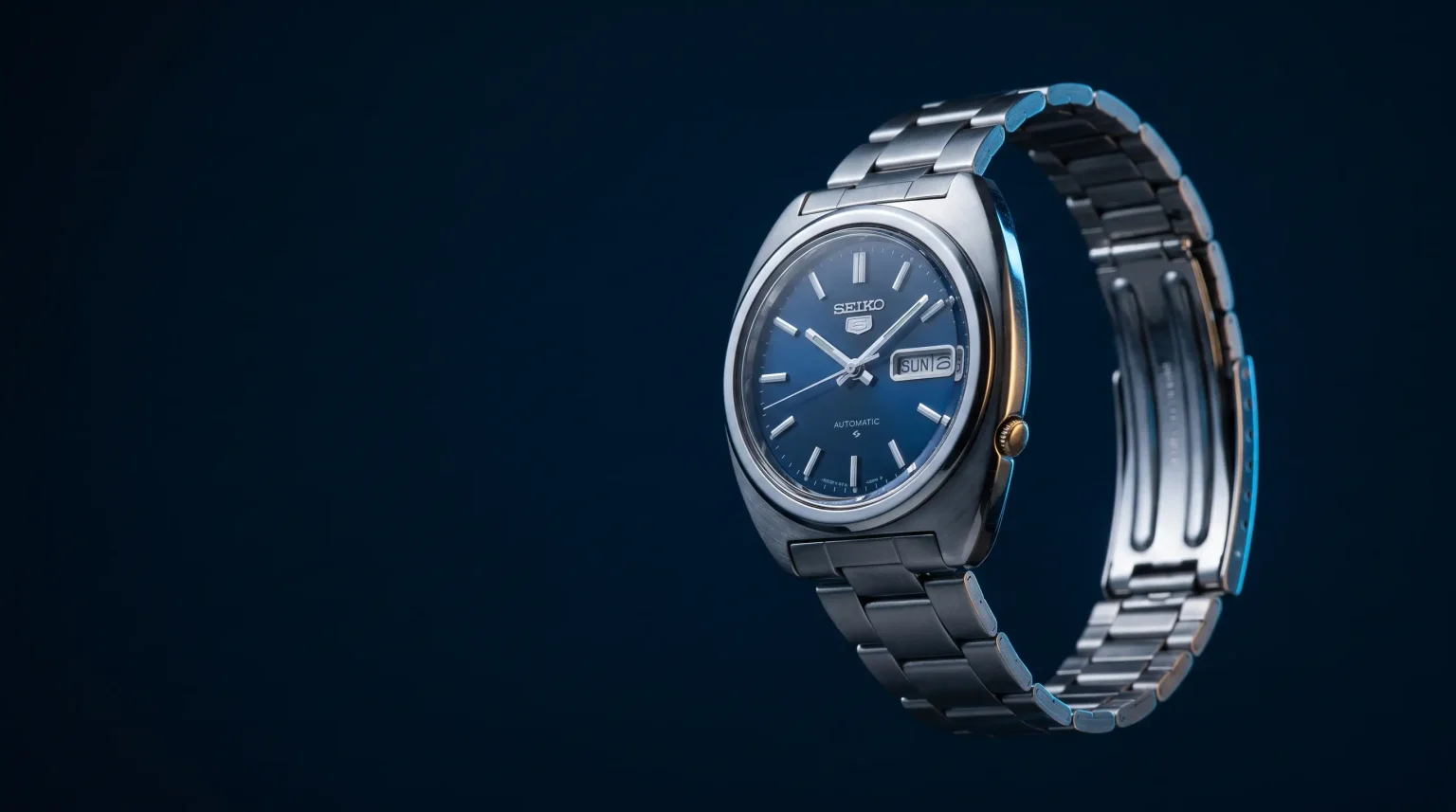 Illustrative blue-dial vintage Seiko watch with a silver bracelet